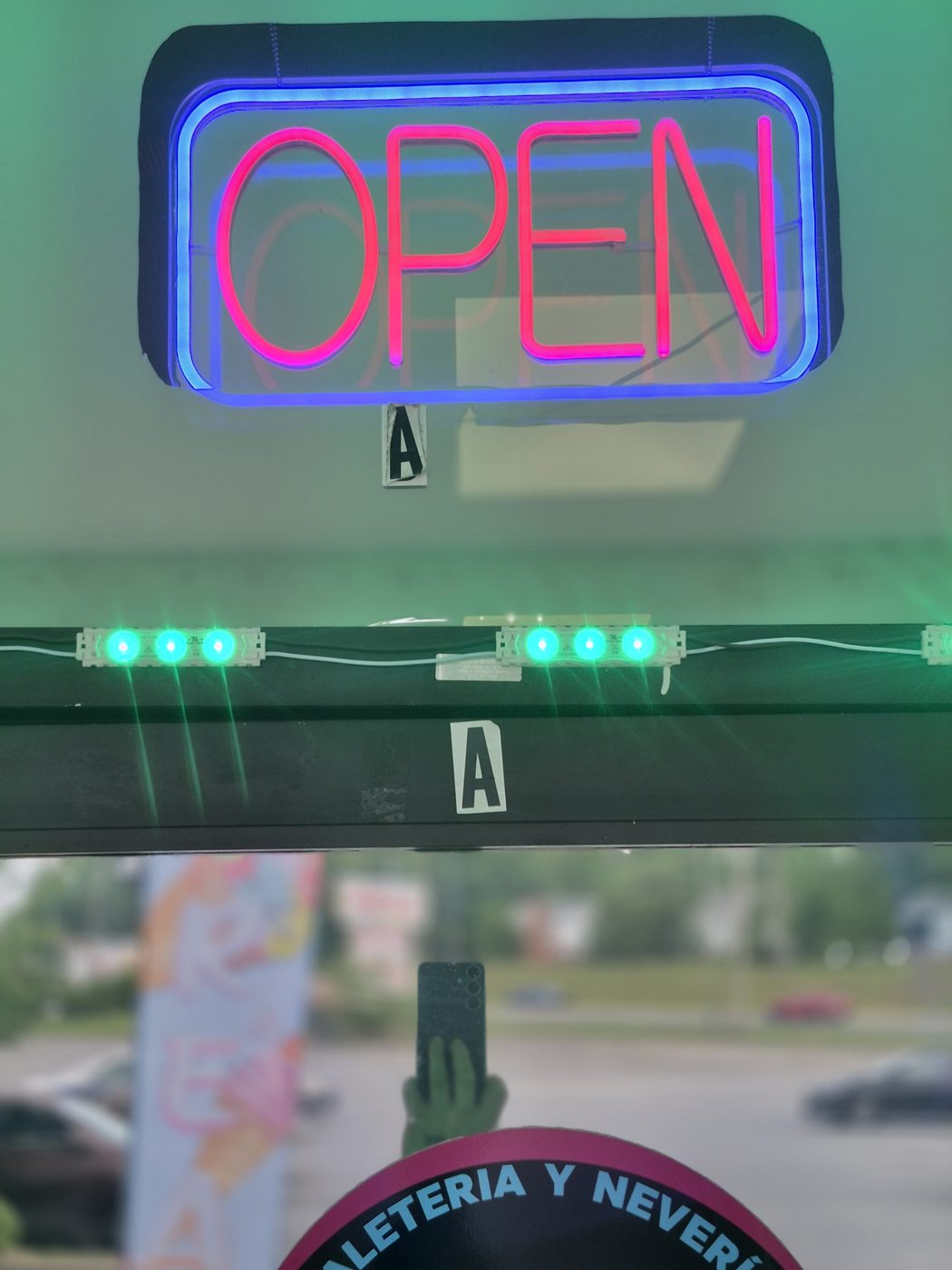 Neon OPEN sign glowing in the window of Ana's Ice Cream Paradise